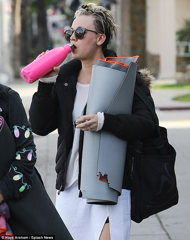 Woman walking with yoga mat
